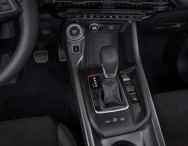 Ignition control for the 2025 Dodge Hornet is positioned prominently on the console; additional performance controls are placed at the fingertips with a button on the performance-oriented steering wheel that enables drivers to choose between Sport and Standard drive modes for the GT and hybrid driving modes for the R/T