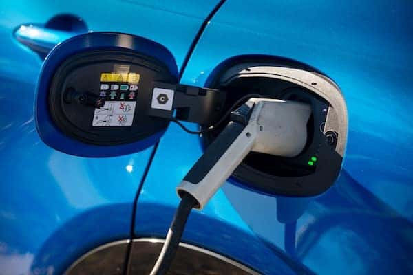 Blue 2025 Dodge Hornet R/T using a Level 2 charger.