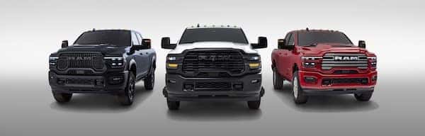 Lineup of Ram heavy duty trucks in blue, white and red.