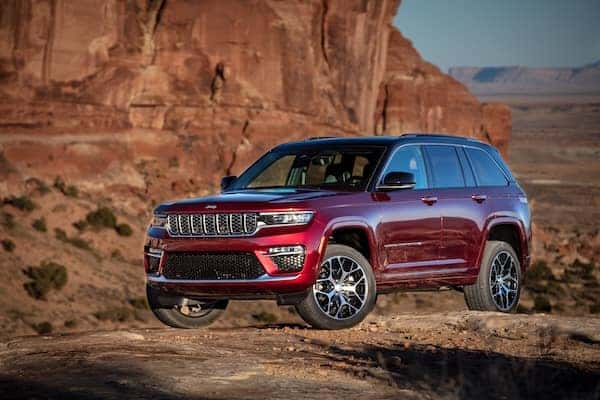 Red 2025 Jeep Grand Cherokee Summit Reserve parked in the mountains