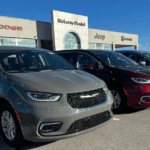 Gray and Red Chrysler Pacifica Minivans lined up on car dealership lot