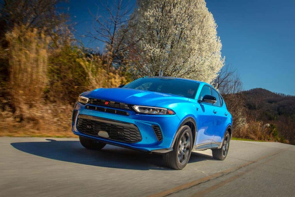 A blue 2025 Dodge Hornet on the road.