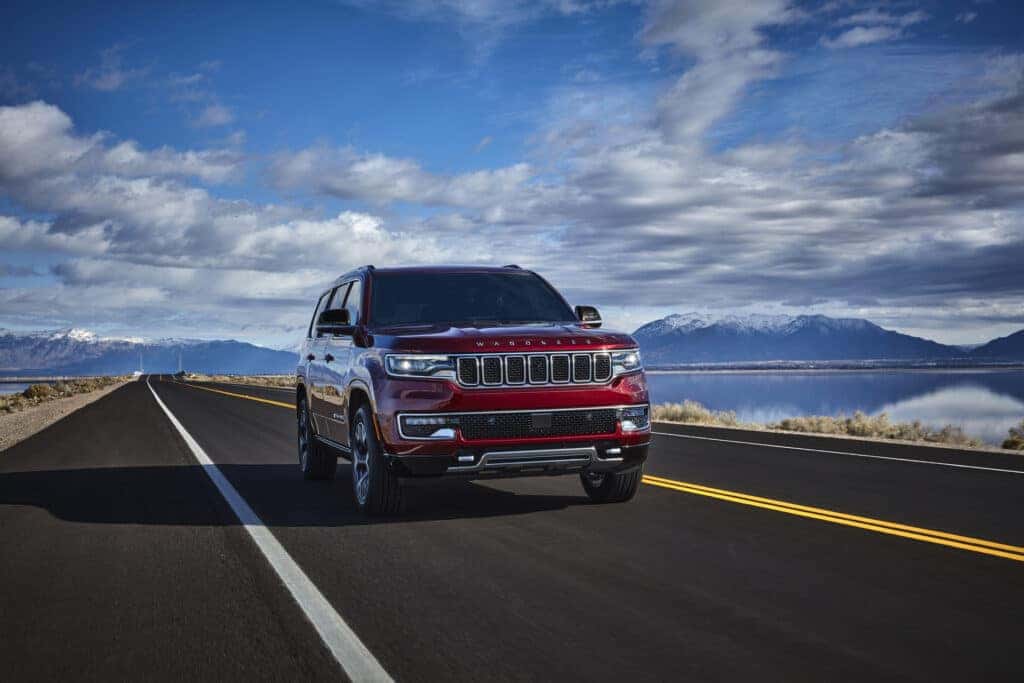 A red 2025 Jeep Wagoneer on an open road.