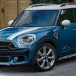 4-Door Blue MINI Parked Outside of Garage