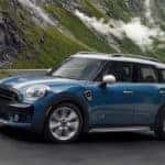 Image of a Mini Countryman driving on a windy road through the mountains.