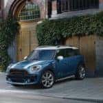 MINI Countryman backed up in a driveway along a cobblestone path.