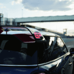 MINI Cooper JCW GP from the rear, screaming the spoiler on a race track.