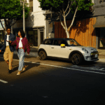 Young couple walking near their new MINI SE All Electric
