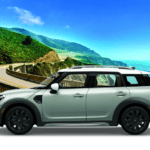 MINI Countryman Oxford Edition set against a beach and hill backdrop.
