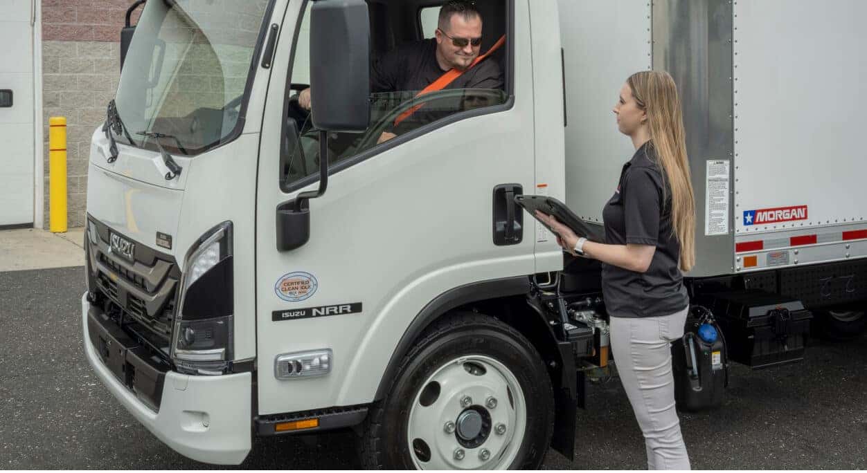 Isuzu NRR Diesel split view showing driver check-in and maintenance in a fleet service setting.