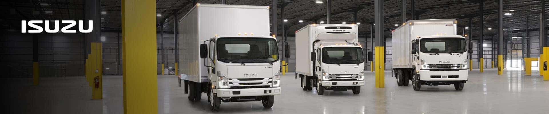 Isuzu Commercial Trucks in a warehouse interior