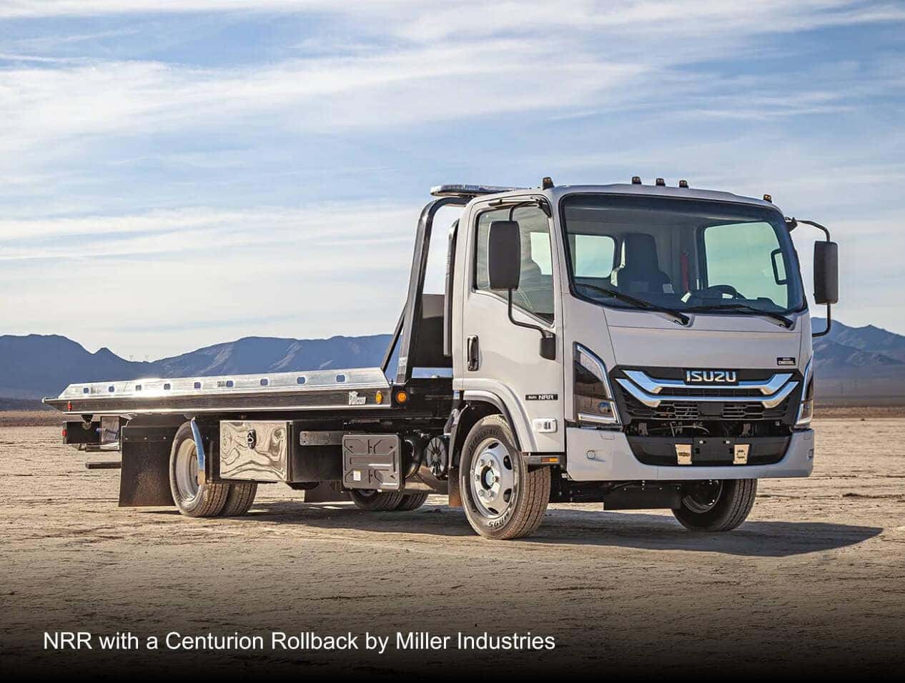 Isuzu NRR with a Centurion Rollback by Miller Industries in a desert landscape