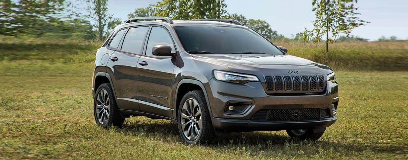 A grey 2022 Jeep Cherokee is shown from the front parked in a grass field after leaving a Jeep dealership in Los Angeles.