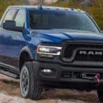 A blue 2019 Ram 2500 powers through a dirt trail