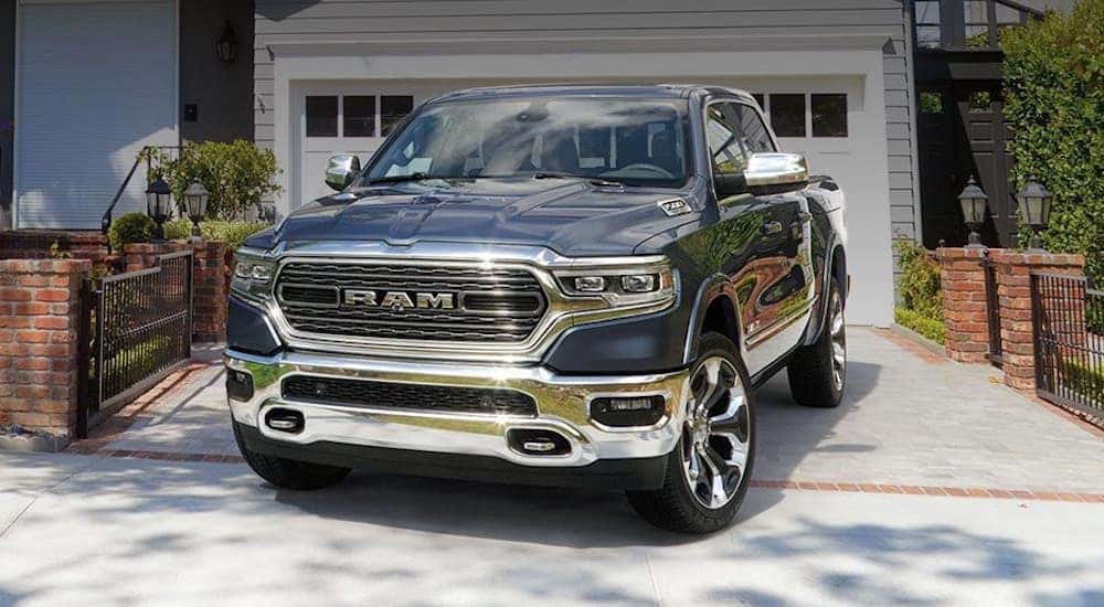 A grey 2020 Ram 1500 with chrome accents is parked in front of a Costa Mesa, CA home.