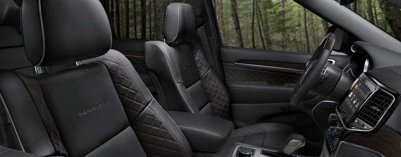 The sleek black leather interior of a 2020 Grand Cherokee Summit is shown.