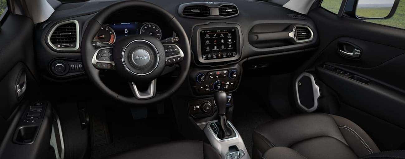 The front black leather interior of a 2020 Jeep Renegade is shown.