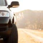 The front of an SUV is shown in the sunlight.