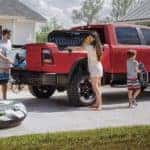 A family is loading the Rambox on their red 2020 Ram 1500, outside Costa Mesa, CA.