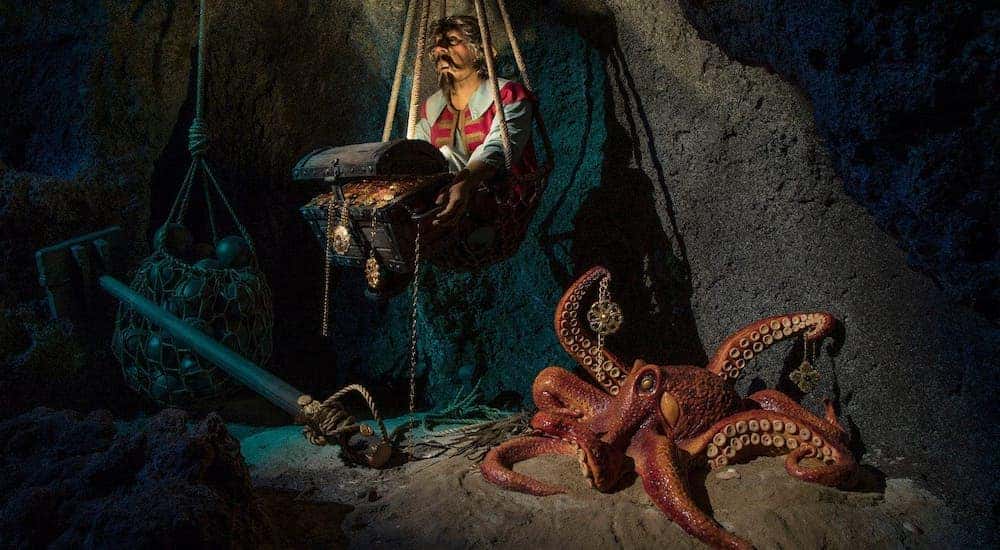A pirate and octopus are in a cave on the Pirates of the Caribbean ride.