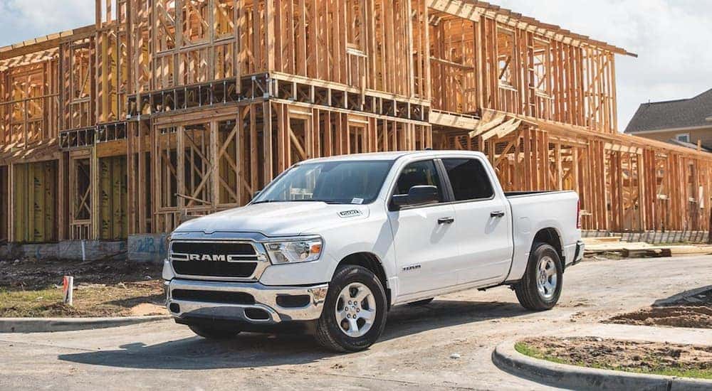 A white 2020 Ram 1500 is leaving a construction site in Costa Mesa, CA.