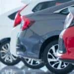 A line of cars at a used car dealership near me are in a showroom.