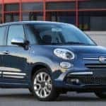 You'll find used cars for sale at Orange Coast, like this blue 2018 Fiat 500L parked in front of a building in Costa Mesa.