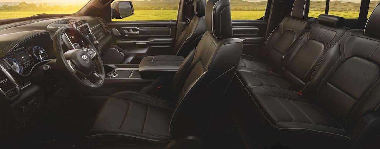 The black interior of a 2020 Ram 1500 is shown from the side.