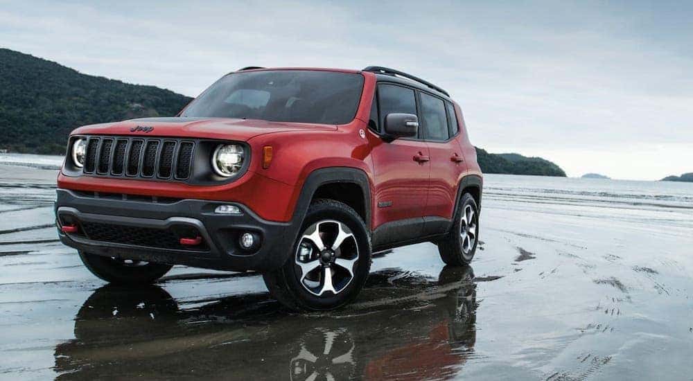 A red 2020 Jeep Renegade Trailhawk is parked on a beach near Costa Mesa, CA.