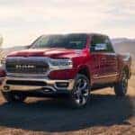 A red 2019 Ram 1500 is parked on a ranch.