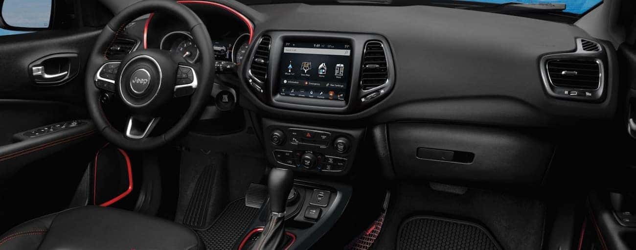 The black interior with red detail in a 2020 Jeep Compass is shown.