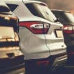 A row of SUVs are shown from the trunk on a lot in Costa Mesa, CA.