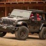 A grey Jeep Wrangler Rubicon 392 Concept, soon to be an available Jeep for sale, is parked in front of a barn near Costa Mesa, CA.