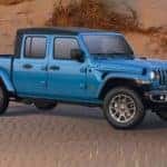 A blue 2021 Jeep Gladiator 80th Anniversary is shown angled right in the desert after leaving a Jeep dealership near you.