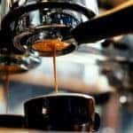 A machine is brewing a fresh cup of coffee.
