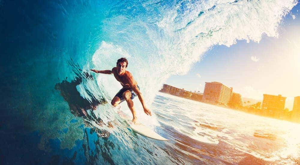 A surfer is under a wave at an Orange County beach.