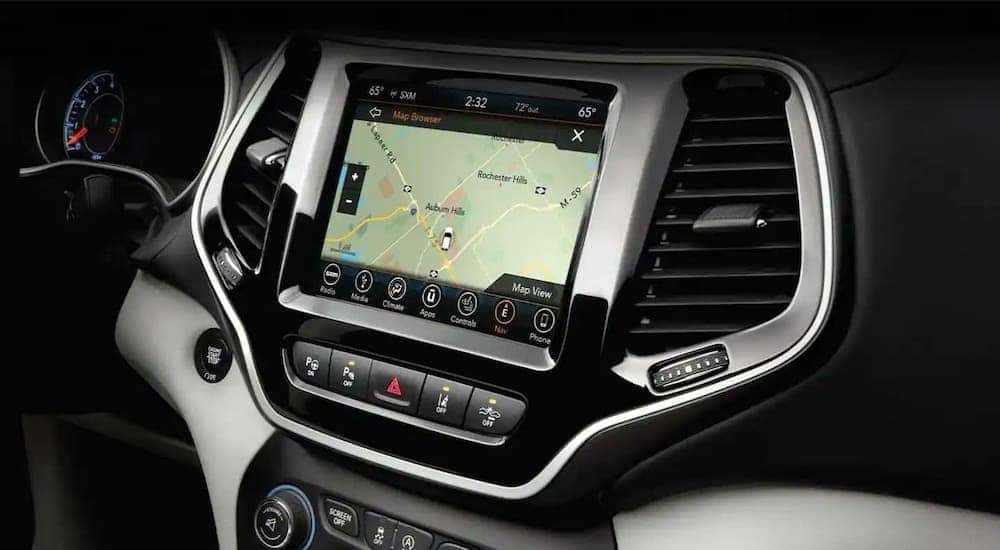 A closeup shows the infotainment screen on a 2019 used Jeep Cherokee.