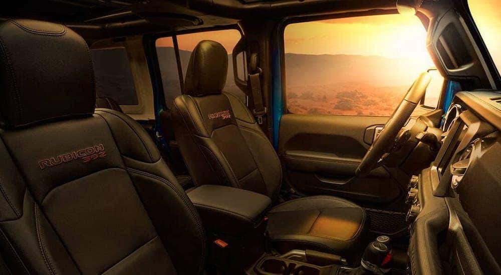 The interior and custom stitching inside a 2021 Jeep Wrangler Unlimited Rubicon 392 are shown.