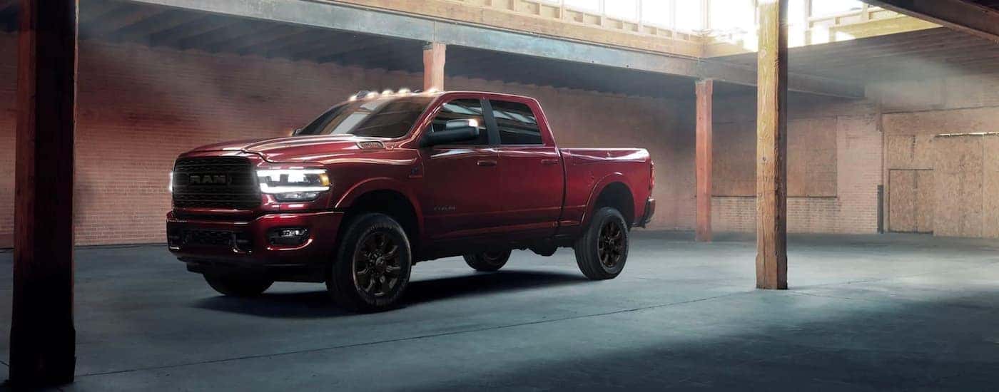 A red 2021 Ram 2500 Limited Night Edition is shown parked in a warehouse.