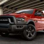 A red 2019 2019 Ram 1500 Classic is parked under a highway overpass.