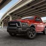 A red 2019 Ram 1500 Classic Warlock is parked under a bridge.