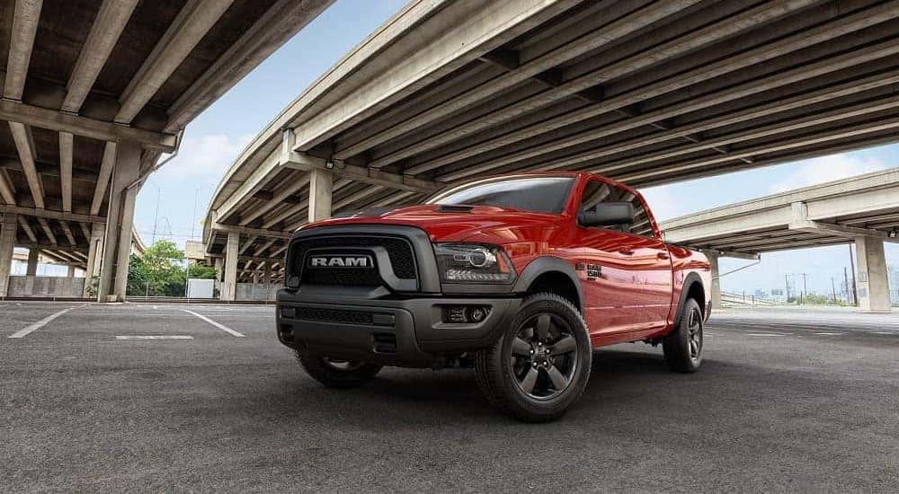 A red 2019 Ram 1500 Classic Warlock is parked under a bridge.