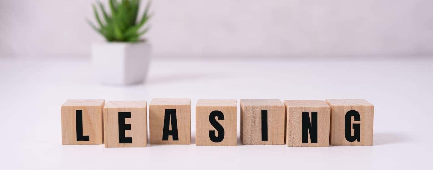 A set of wooden blocks is shown that says 'leasing'.