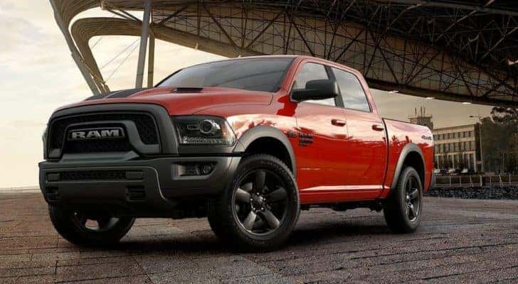 A red 2019 Ram 1500 Classic is parked under an airport hanger.