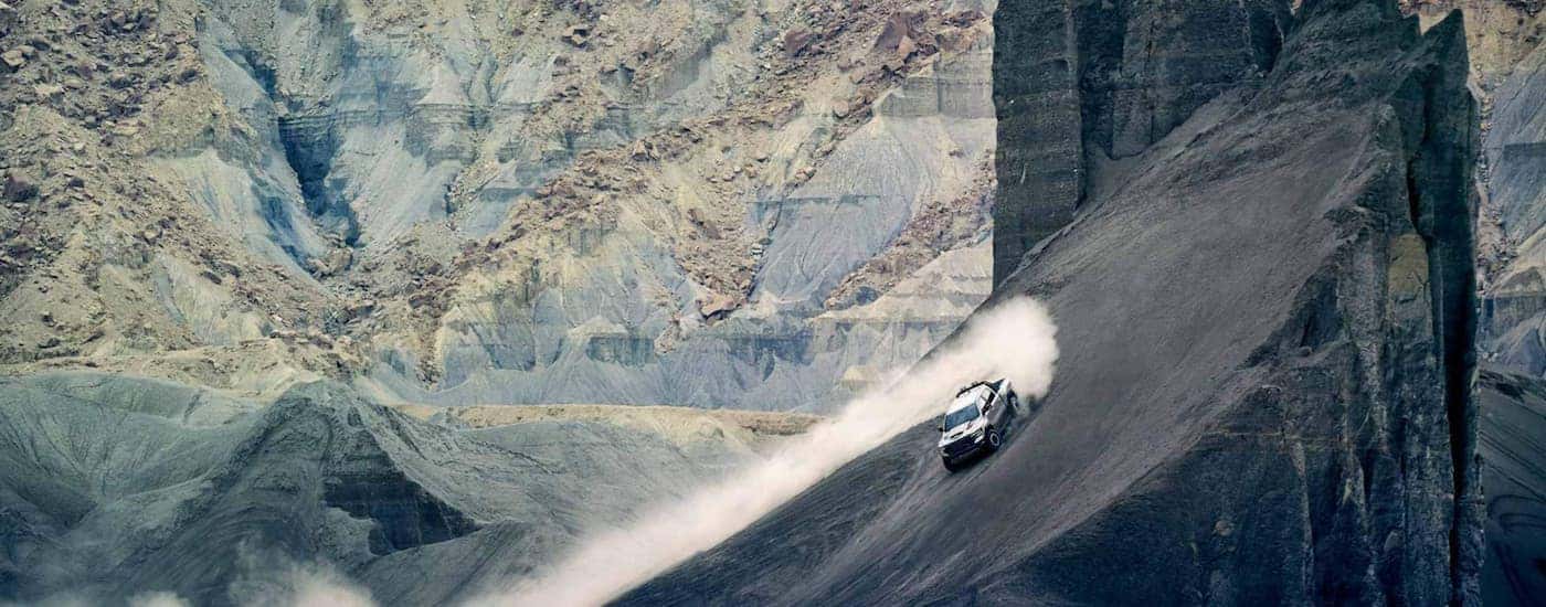 A silver 2021 Ram TRX is driving through the desert.