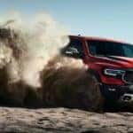 A red 20210 Ram TRX is off-roading in the desert after leaving a California Ram TRX dealer.