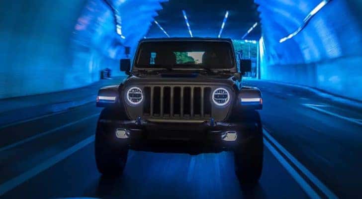 The front of a 2021 Jeep Wrangler 4xe is shown driving through a tunnel to a California Jeep Wrangler 4xe dealer.