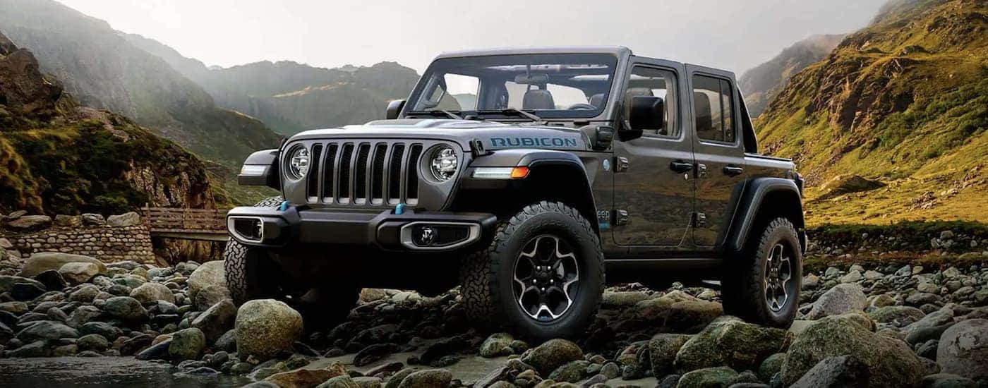 A grey 2022 Jeep Wrangler is shown from the front parked in the mountains after leaving a California Jeep Wrangler 4xe dealer.