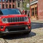 A red 2021 Jeep Renegade is shown from the front parked on a city street.