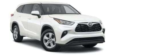 A white 2021 Toyota Highlander LE is angled right.